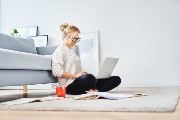 Travel advisor working on a laptop from the living room