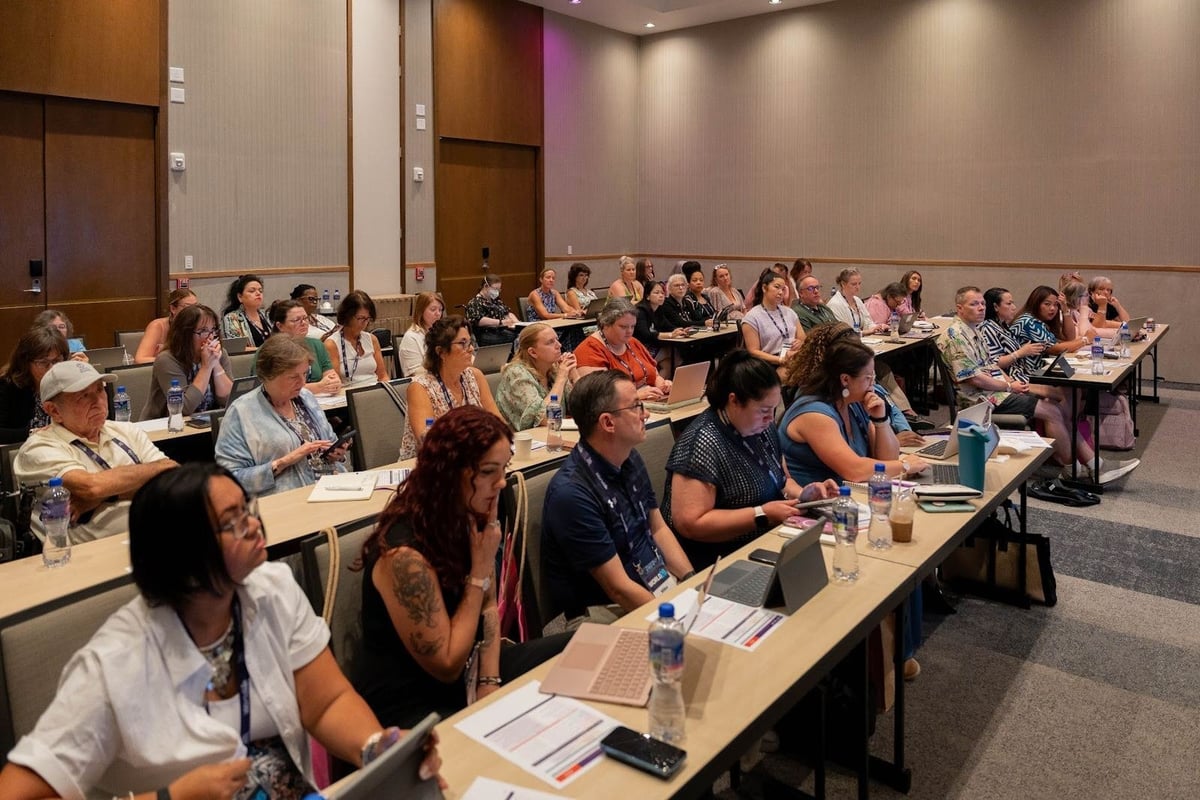 Travel agency owners learning together at a WorldVia Travel Network event